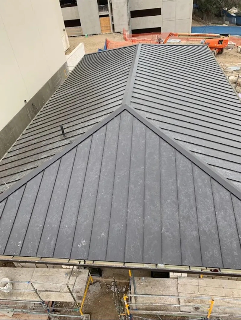 Commercial metal roof construction with crane equipment in Rotonda